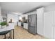 Spacious kitchen with stainless steel appliances, white cabinets, and tile flooring at 9395 W Kentucky Ave, Lakewood, CO 80226