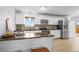 Bright kitchen featuring modern appliances, white cabinetry, and ample counter space at 9395 W Kentucky Ave, Lakewood, CO 80226