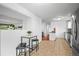 Open kitchen area with breakfast bar and seamless flow into the living space at 9395 W Kentucky Ave, Lakewood, CO 80226
