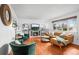 Cozy living room with a fireplace, large window, and stylish furnishings at 9395 W Kentucky Ave, Lakewood, CO 80226