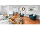 Open-concept living room and dining area with hardwood floors and modern decor at 9395 W Kentucky Ave, Lakewood, CO 80226