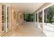Covered back patio is great for entertaining, with brick facade and ceiling fan at 2209 Green Oaks Ln, Greenwood Village, CO 80121