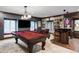 Basement features pool table, bar, large television and cozy seating at 2209 Green Oaks Ln, Greenwood Village, CO 80121