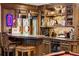 Basement wet bar features pendant lights, granite counters and beautiful stained glass at 2209 Green Oaks Ln, Greenwood Village, CO 80121