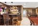 Finished basement bar with seating, shelving, and direct access to billiards area at 2209 Green Oaks Ln, Greenwood Village, CO 80121