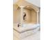 Elegant bathroom with a soaking tub featuring mosaic tile and roman columns at 2209 Green Oaks Ln, Greenwood Village, CO 80121