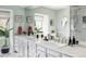 Bright bathroom with a double vanity, plants, and a glass-enclosed shower at 2209 Green Oaks Ln, Greenwood Village, CO 80121