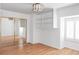 Bright bedroom features hardwood floors, closet with mirrored doors, and built-in shelving at 2209 Green Oaks Ln, Greenwood Village, CO 80121