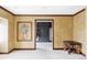 Large bedroom with decorative walls and trim, neutral carpet, painting, and door to a walk-in closet at 2209 Green Oaks Ln, Greenwood Village, CO 80121