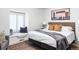 Modern bedroom with a large bed, neutral walls, a window seat, and natural light at 2209 Green Oaks Ln, Greenwood Village, CO 80121