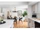 Elegant dining area featuring a glass-top table, stylish chairs, and hardwood floors, bathed in natural light at 2209 Green Oaks Ln, Greenwood Village, CO 80121
