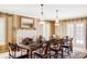 Formal dining room with elegant chandeliers, a fireplace, and a large table for hosting gatherings at 2209 Green Oaks Ln, Greenwood Village, CO 80121