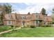 Charming brick home featuring a well-manicured front lawn and unique roofline at 2209 Green Oaks Ln, Greenwood Village, CO 80121