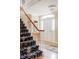 Welcoming foyer with a decorative staircase, hardwood floors, and ample natural light at 2209 Green Oaks Ln, Greenwood Village, CO 80121