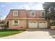 Charming brick home features a two-car garage and well-manicured lawn at 2209 Green Oaks Ln, Greenwood Village, CO 80121