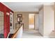 Elegant hallway featuring neutral walls, wood railing and trim, leading to bedrooms, living room, and other areas at 2209 Green Oaks Ln, Greenwood Village, CO 80121