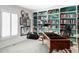 Cozy office space with custom built-in shelving, a desk, and a window for natural light at 2209 Green Oaks Ln, Greenwood Village, CO 80121