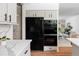 Bright kitchen with modern appliances and quartz countertops, seamlessly flowing into the adjacent living room at 2209 Green Oaks Ln, Greenwood Village, CO 80121