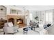 Bright and airy living room with a cozy brick fireplace and ample shelving at 2209 Green Oaks Ln, Greenwood Village, CO 80121