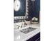 Close up of powder room with a unique mosaic sink and custom lighting at 2209 Green Oaks Ln, Greenwood Village, CO 80121