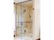Spacious glass shower with bench and dual shower heads with bronze hardware and tile walls at 2209 Green Oaks Ln, Greenwood Village, CO 80121
