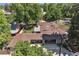 Aerial view of the home with mature trees and a covered outdoor seating area with a dining table at 801 S Steele St, Denver, CO 80209