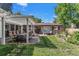 This outdoor space offers a pergola, a dining table, a seating area, and manicured flower beds at 801 S Steele St, Denver, CO 80209