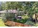 A fully fenced backyard features a manicured lawn, mature trees, and a luxurious hot tub for relaxing at 801 S Steele St, Denver, CO 80209