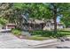 Charming single-story brick home with lush green lawn, mature trees, and three car garage at 801 S Steele St, Denver, CO 80209