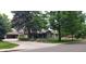 Beautifully landscaped home featuring a detached garage and mature trees at 801 S Steele St, Denver, CO 80209