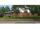 Exterior side view of home with a wooden fence, providing privacy and security at 801 S Steele St, Denver, CO 80209