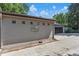 Attached garage with a neutral-colored brick facade, driveway, and landscape features for enhanced curb appeal at 801 S Steele St, Denver, CO 80209