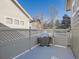 Private backyard with snow-covered patio and grill at 2676 S Troy Ct, Aurora, CO 80014