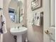 Clean bathroom with pedestal sink and decorative accents at 2676 S Troy Ct, Aurora, CO 80014