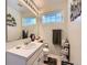 Well-lit bathroom featuring a vanity, toilet, and ample storage at 2676 S Troy Ct, Aurora, CO 80014