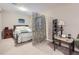 Basement bedroom with a bed, room divider, and small side table at 2676 S Troy Ct, Aurora, CO 80014