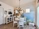 Charming breakfast nook with painted mural and white table set at 2676 S Troy Ct, Aurora, CO 80014