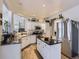 Modern kitchen with white cabinets, granite countertops, and stainless steel appliances at 2676 S Troy Ct, Aurora, CO 80014