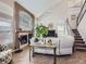 Living room with hardwood floors, fireplace, and a view of the staircase at 2676 S Troy Ct, Aurora, CO 80014