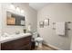 Well-appointed half bath featuring modern vanity, wood floors, and stylish decor at 27341 Ridge Trl, Conifer, CO 80433