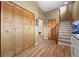 Bright entryway with wooden floors, closet space, and staircase to the upper level at 27341 Ridge Trl, Conifer, CO 80433