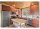 Well-equipped kitchen with stainless steel appliances, wood cabinets, and butcher block island at 27341 Ridge Trl, Conifer, CO 80433