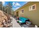 Inviting outdoor patio with a comfortable seating area, grill, and string lights, perfect for entertaining and relaxation at 27341 Ridge Trl, Conifer, CO 80433