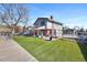 A backyard with artificial turf, patio area, and fencing provides ample space for outdoor activities and privacy at 1691 S Arbutus Pl, Lakewood, CO 80228