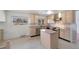 Well-lit kitchen features wood cabinets, island and stainless steel appliances at 1691 S Arbutus Pl, Lakewood, CO 80228