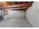 Unfinished basement featuring concrete walls, exposed ceiling, washer and dryer at 3720 S Fairplay Way, Aurora, CO 80014