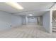 Large basement with neutral carpet, blue walls, drop ceiling, and exposed support beam at 3720 S Fairplay Way, Aurora, CO 80014