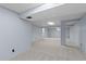 Unfinished basement featuring gray carpet, light blue walls, drop ceiling, and exposed support beam at 3720 S Fairplay Way, Aurora, CO 80014