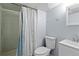 Basement bathroom featuring a toilet, sink, and shower with curtain at 3720 S Fairplay Way, Aurora, CO 80014