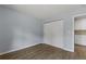 A bright bedroom featuring ample closet space and wood floors, perfect for storage and comfort at 3720 S Fairplay Way, Aurora, CO 80014